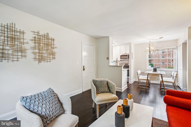 1712 W Abingdon Dr Unit 102, Alexandria, VA 22314 - living area featuring a chandelier, dark wood finished floors, and baseboards