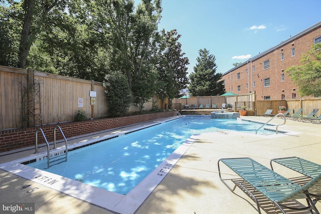 1712 W Abingdon Dr Unit 102, Alexandria, VA 22314 - community pool with a patio area and a fenced backyard