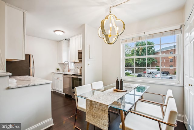 1712 W Abingdon Dr Unit 102, Alexandria, VA 22314 - dining space with dark wood-style floors and a chandelier