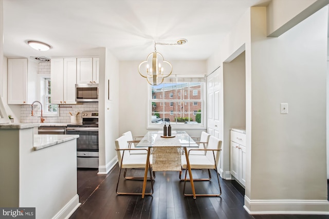 1712 W Abingdon Dr Unit 102, Alexandria, VA 22314 - dining area with a chandelier, dark wood-style flooring, and baseboards