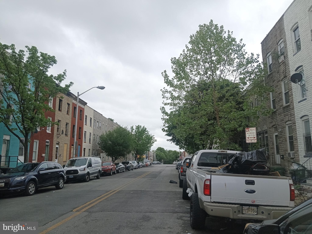view of asphalt street featuring street lighting