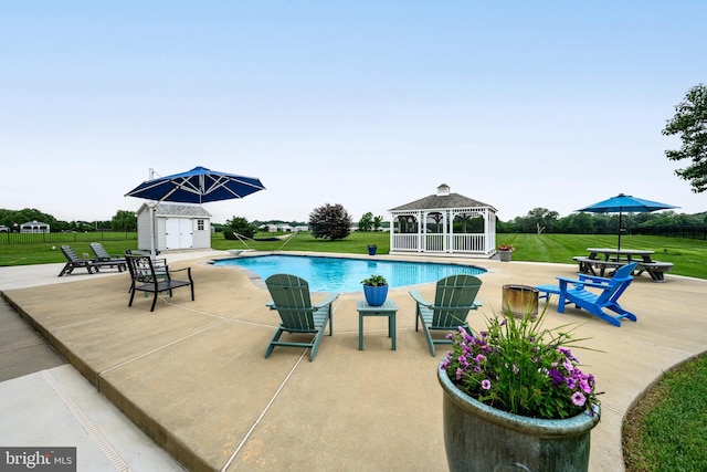 301 Nottingham Ln, Queenstown, MD 21658 - view of swimming pool with a gazebo, a yard, a patio, and a shed