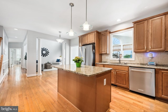 301 Nottingham Ln, Queenstown, MD 21658 - kitchen with stainless steel appliances, a kitchen island, brown cabinetry, decorative backsplash, and recessed lighting