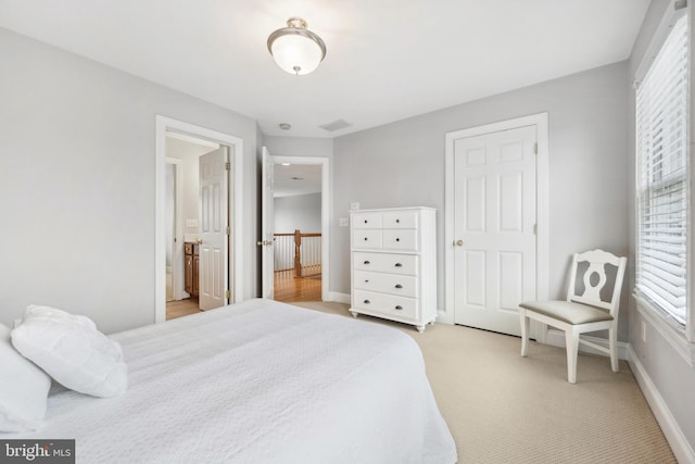 301 Nottingham Ln, Queenstown, MD 21658 - bedroom featuring multiple windows and light carpet
