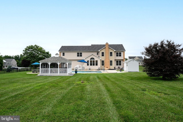 301 Nottingham Ln, Queenstown, MD 21658 - rear view of house featuring a gazebo, a storage shed, a chimney, and a patio