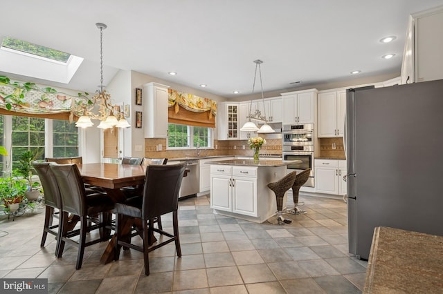 56 Saxon Way, Skillman, NJ 08558 - dining room with a skylight, recessed lighting, and a chandelier