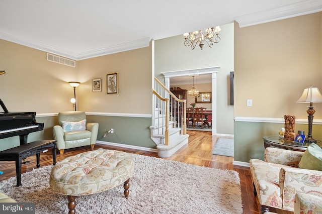 56 Saxon Way, Skillman, NJ 08558 - living area with a chandelier, crown molding, wood finished floors, stairs, and baseboards