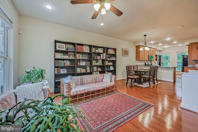 311 I St SE, Washington, DC 20003 - living room with light wood-style floors, ceiling fan, recessed lighting, baseboards, and a chandelier