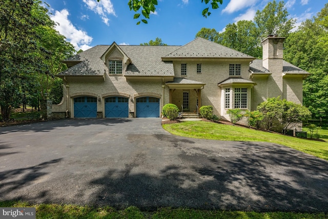 601 Utterback Store Rd, Great Falls, VA 22066 - french country inspired facade with asphalt driveway, a chimney, a garage, and a high end roof
