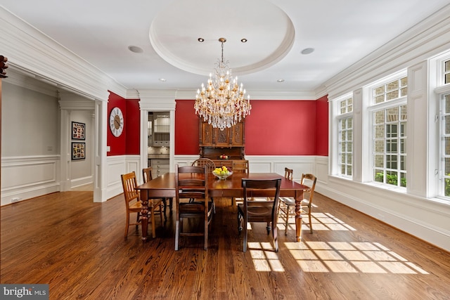 601 Utterback Store Rd, Great Falls, VA 22066 - dining area featuring wood finished floors, a chandelier, wainscoting, crown molding, and a decorative wall