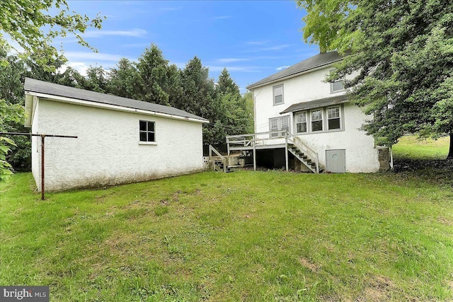 view of green lawn featuring stairs and a wooden deck