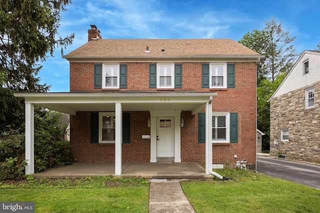 626 Lukens Ave, Upper Darby, PA 19082 - view of front of property with a chimney, brick siding, covered porch, and a front yard