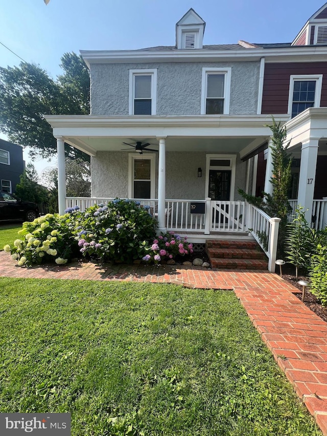19 E Del Ray Ave E, Alexandria, VA 22301 - view of front facade featuring a porch, stucco siding, and a front yard