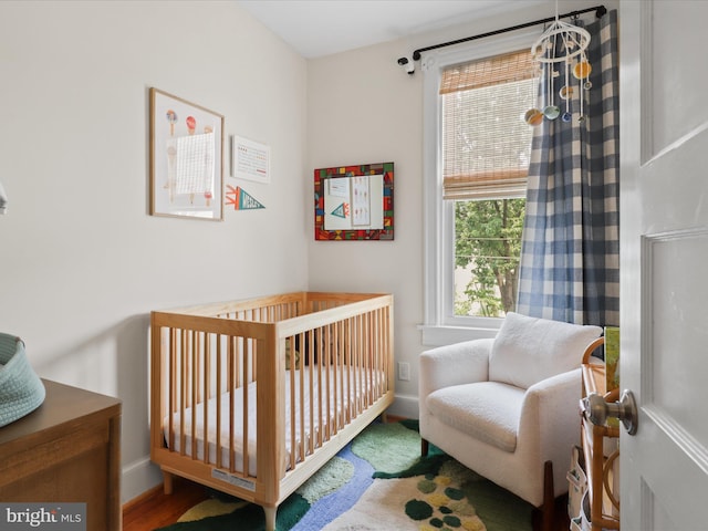 19 E Del Ray Ave E, Alexandria, VA 22301 - bedroom with multiple windows, a crib, baseboards, and wood finished floors