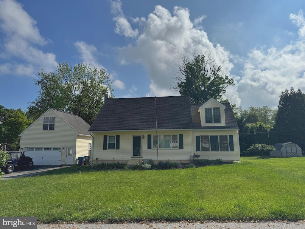 204 Seal Ln, West Chester, PA 19380 - cape cod house with an outbuilding, a front lawn, roof with shingles, a storage shed, and driveway