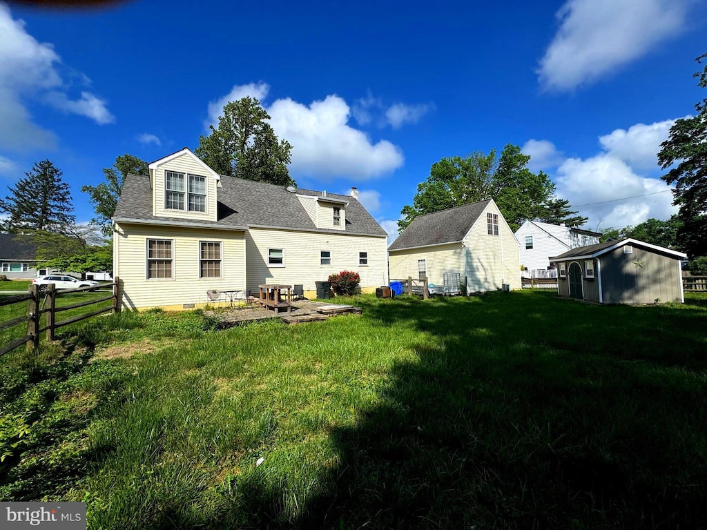 204 Seal Ln, West Chester, PA 19380 - back of house with an outbuilding, a storage unit, a patio, and roof with shingles