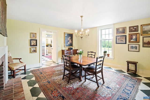 3276 Buckingham Springs Rd, Dillwyn, VA 23936 - dining space with a chandelier, baseboards, and a brick fireplace