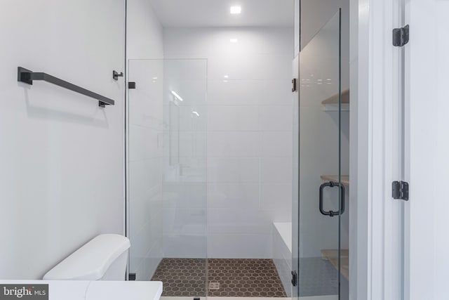full bath with toilet and a shower stall