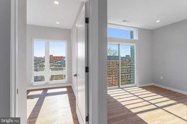 spare room with wood finished floors and baseboards