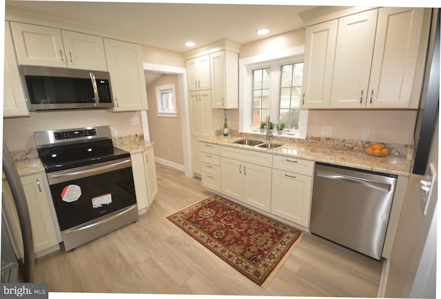 204 W Chew Ave, Saint Michaels, MD 21663 - kitchen with stainless steel appliances, a sink, light wood-style floors, light stone countertops, and recessed lighting