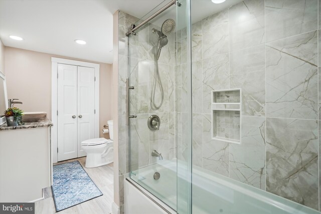 204 W Chew Ave, Saint Michaels, MD 21663 - bathroom with enclosed tub / shower combo, toilet, recessed lighting, wood finished floors, and vanity