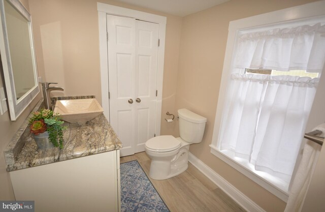 204 W Chew Ave, Saint Michaels, MD 21663 - bathroom with wood finished floors, toilet, vanity, and baseboards