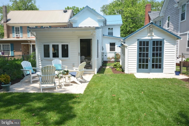 204 W Chew Ave, Saint Michaels, MD 21663 - back of house featuring a patio area, metal roof, and an outbuilding