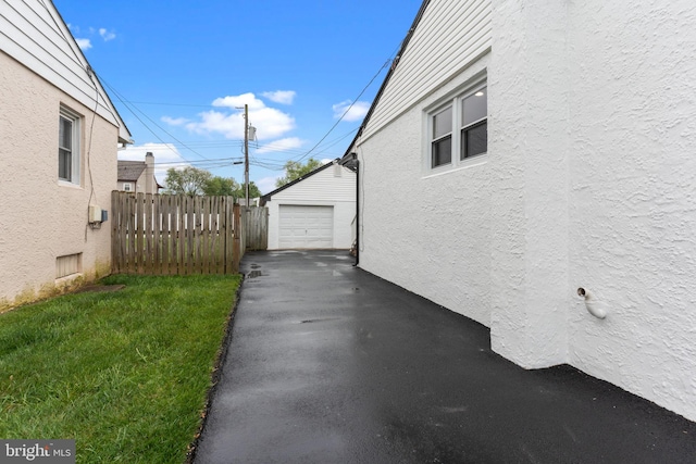 422 Jefferson Ave, Langhorne, PA 19047 - view of property exterior with asphalt driveway, stucco siding, an outdoor structure, and a detached garage