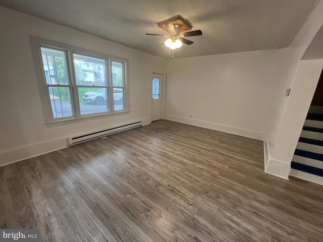 19 S Gold St, Shamokin, PA 17872 - unfurnished room featuring baseboard heating, wood finished floors, baseboards, and a ceiling fan