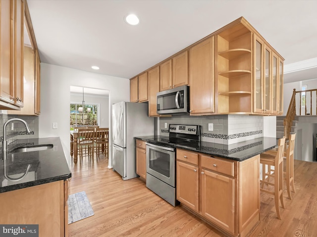 25109 Hickory Ridge Ln, Gaithersburg, MD 20882 - kitchen featuring stainless steel appliances, open shelves, light wood-style floors, tasteful backsplash, and dark stone counters