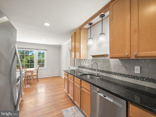25109 Hickory Ridge Ln, Gaithersburg, MD 20882 - kitchen featuring stainless steel appliances, light wood-type flooring, crown molding, tasteful backsplash, and dark stone countertops