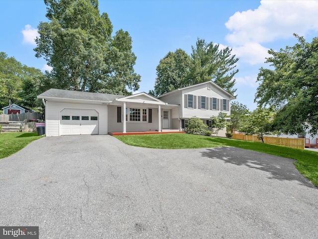 25109 Hickory Ridge Ln, Gaithersburg, MD 20882 - tri-level home featuring asphalt driveway, a garage, and covered porch