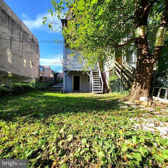 view of yard featuring stairway and a wooden deck