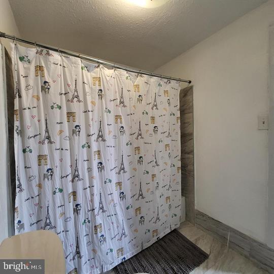 bathroom featuring curtained shower