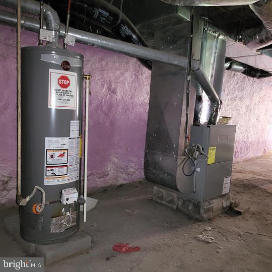 utility room with gas water heater and heating unit