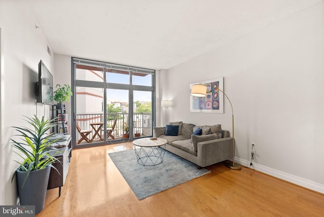 2120 Vermont Ave NW Unit 411, Washington, DC 20001 - living area with wood finished floors, baseboards, and expansive windows