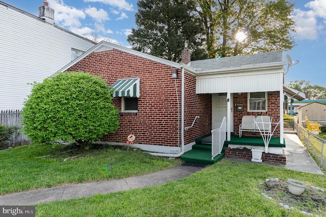 3127 N 5th St, Harrisburg, PA 17110 - view of front facade with brick siding, a chimney, and a shingled roof