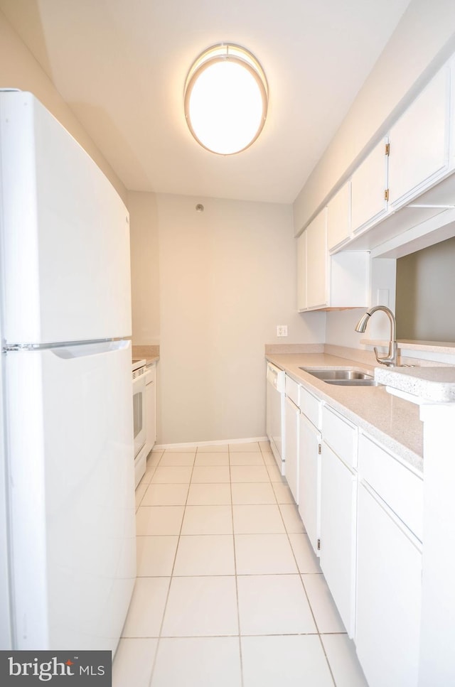 3313 Wyndham Cir Unit 4209, Alexandria, VA 22302 - kitchen featuring white appliances, a sink, light countertops, light tile patterned floors, and baseboards