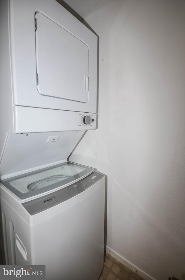 3313 Wyndham Cir Unit 4209, Alexandria, VA 22302 - laundry room featuring stacked washer / drying machine and baseboards