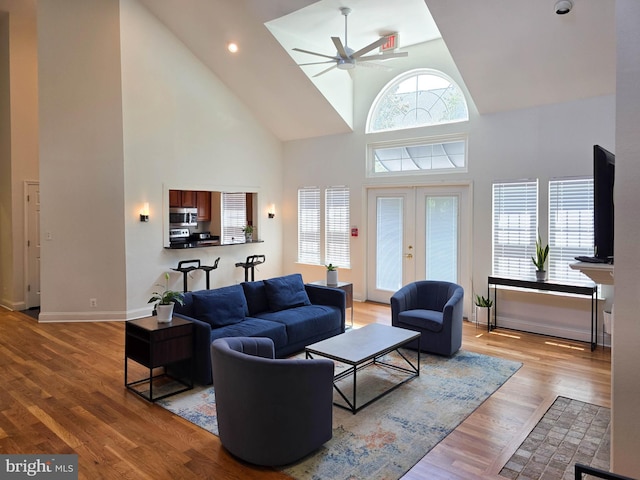 3313 Wyndham Cir Unit 4209, Alexandria, VA 22302 - living area featuring high vaulted ceiling, ceiling fan, french doors, wood finished floors, and baseboards