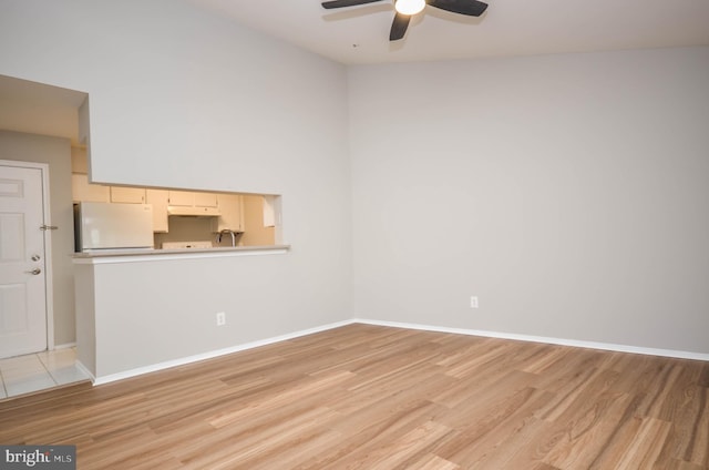 3313 Wyndham Cir Unit 4209, Alexandria, VA 22302 - unfurnished room with light wood finished floors, ceiling fan, and baseboards