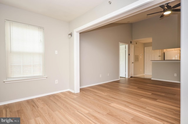 3313 Wyndham Cir Unit 4209, Alexandria, VA 22302 - unfurnished living room featuring ceiling fan, light wood-type flooring, and baseboards