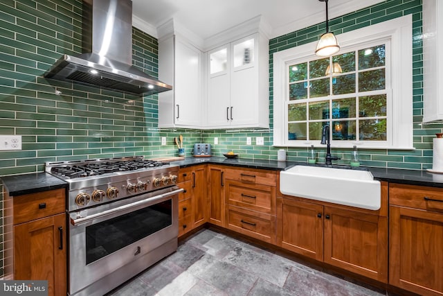 109 Deepdene Rd, Baltimore, MD 21210 - kitchen with high end stove, wall chimney exhaust hood, a sink, backsplash, and decorative light fixtures