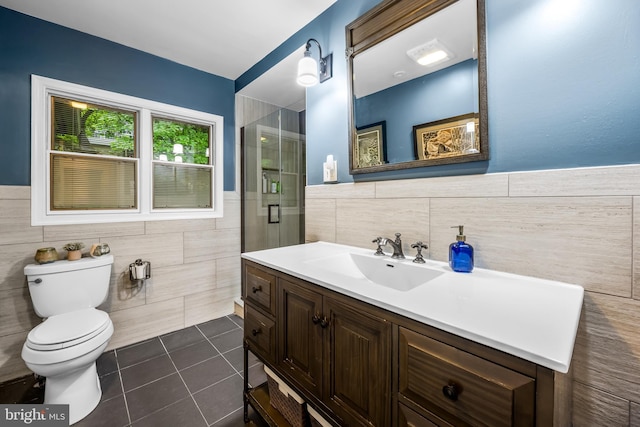 109 Deepdene Rd, Baltimore, MD 21210 - bathroom featuring tile walls, vanity, tile patterned floors, toilet, and an enclosed shower