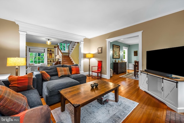 109 Deepdene Rd, Baltimore, MD 21210 - living area featuring decorative columns, stairway, hardwood / wood-style floors, ornamental molding, and baseboards