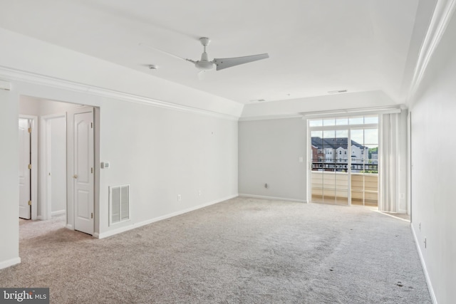 carpeted spare room featuring baseboards and ceiling fan