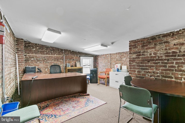 carpeted office with brick wall