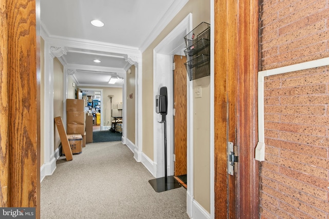 corridor with carpet floors, crown molding, baseboards, and recessed lighting