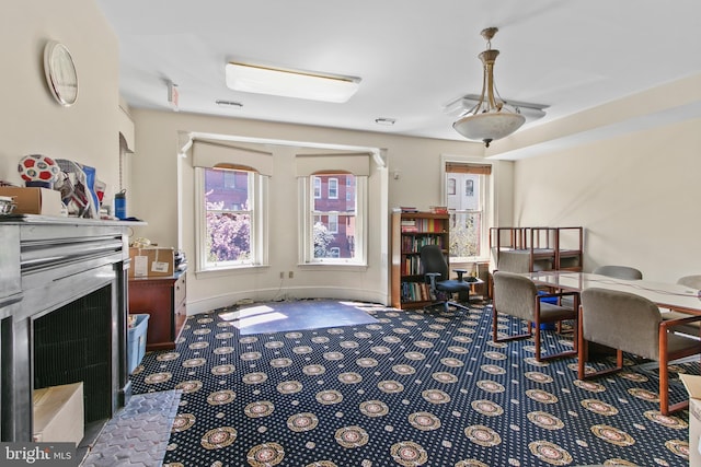 office space with carpet floors and a fireplace