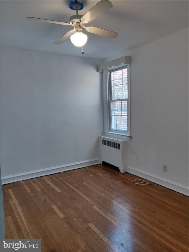 3138 Longshore Ave, Philadelphia, PA 19149 - empty room with radiator heating unit, wood-type flooring, a ceiling fan, and baseboards